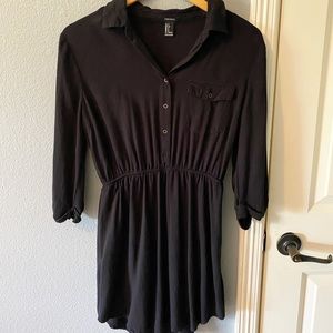 Black short dress with elbow length long sleeve.